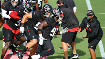Aug 27, 2020; Flowery Branch, GA, USA; Atlanta Falcons defensive tackle Grady Jarrett (front right) leads the defense through an agility drill during training camp on Thursday, August 27, 2020 in Flowery Branch. Mandatory Credit: Curtis Compton/Pool Photo-USA TODAY Sports
