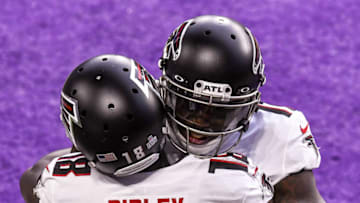 Oct 18, 2020; Minneapolis, Minnesota, USA; Atlanta Falcons wide receiver Calvin Ridley (18) is congratulated on his 8-yard touchdown reception from Matt Ryan (not pictured) by wide receiver Julio Jones (11) in the second quarter against the Minnesota Vikings at U.S. Bank Stadium. Mandatory Credit: Nick Wosika-USA TODAY Sports