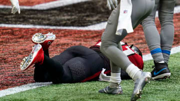 Oct 25, 2020; Atlanta, Georgia, USA; Atlanta Falcons running back Todd Gurley II (21) scores a touchdown while trying to remain short of the goal line against the Detroit Lions during the second half at Mercedes-Benz Stadium. Mandatory Credit: Dale Zanine-USA TODAY Sports