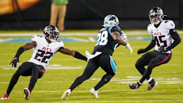 Oct 29, 2020; Charlotte, North Carolina, USA; Carolina Panthers running back Mike Davis (28) dodges Atlanta Falcons strong safety Keanu Neal (22) and linebacker Deion Jones (45) during the first quarter at Bank of America Stadium. Mandatory Credit: Jim Dedmon-USA TODAY Sports