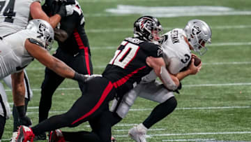 Nov 29, 2020; Atlanta, Georgia, USA; Las Vegas Raiders quarterback Nathan Peterman (3) is tackled by Atlanta Falcons defensive end John Cominsky (50) during the second half at Mercedes-Benz Stadium. Mandatory Credit: Dale Zanine-USA TODAY Sports