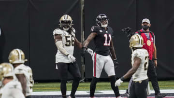 Dec 6, 2020; Atlanta, Georgia, USA; New Orleans Saints linebacker Demario Davis (56) and Atlanta Falcons wide receiver Julio Jones (11) react after a fourth down play during the second half at Mercedes-Benz Stadium. Mandatory Credit: Dale Zanine-USA TODAY Sports