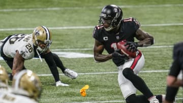Dec 6, 2020; Atlanta, Georgia, USA; Atlanta Falcons wide receiver Julio Jones (11) makes a catch in front of New Orleans Saints cornerback P.J. Williams (26) during the first half at Mercedes-Benz Stadium. Mandatory Credit: Dale Zanine-USA TODAY Sports