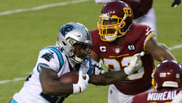 Dec 27, 2020; Landover, Maryland, USA; Carolina Panthers running back Mike Davis (28) carries the ball as Washington Football Team defensive tackle Jonathan Allen (93) chases in the second quarter at FedExField. Mandatory Credit: Geoff Burke-USA TODAY Sports