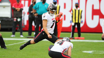 Jan 3, 2021; Tampa, Florida, USA; Atlanta Falcons kicker Younghoe Koo (7) makes a field goal as punter Sterling Hofrichter (4) holds bathe ball against the Tampa Bay Buccaneers during the second half at Raymond James Stadium. Mandatory Credit: Kim Klement-USA TODAY Sports