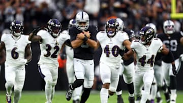 Sep 13, 2021; Paradise, Nevada, USA; Las Vegas Raiders quarterback Marcus Mariota (8) runs the ball ahead of Baltimore Ravens linebacker Patrick Queen (6) defensive back DeShon Elliott (32) linebacker Malik Harrison (40) and cornerback Marlon Humphrey (44) during the first half at Allegiant Stadium. Mandatory Credit: Mark J. Rebilas-USA TODAY Sports