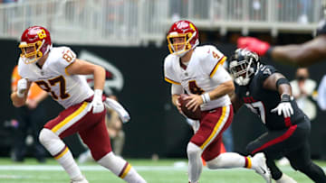 Oct 3, 2021; Atlanta, Georgia, USA; Washington Football Team quarterback Taylor Heinicke (4) runs the ball against the Atlanta Falcons in the second half at Mercedes-Benz Stadium. Mandatory Credit: Brett Davis-USA TODAY Sports