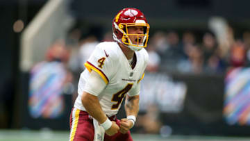 Oct 3, 2021; Atlanta, Georgia, USA; Washington Football Team quarterback Taylor Heinicke (4) celebrates after a go-ahead touchdown throw to running back J.D. McKissic (not pictured) against the Atlanta Falcons in the second half at Mercedes-Benz Stadium. Mandatory Credit: Brett Davis-USA TODAY Sports