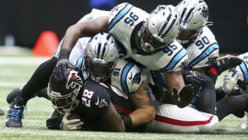 Oct 31, 2021; Atlanta, Georgia, USA; Atlanta Falcons running back Mike Davis (28) is tackled by Carolina Panthers defensive end Morgan Fox (91) and defensive tackle Derrick Brown (95) and defensive end DaQuan Jones (90) in the first quarter at Mercedes-Benz Stadium. Mandatory Credit: Brett Davis-USA TODAY Sports
