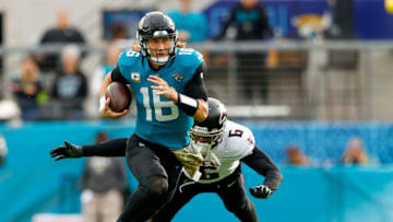 Nov 28, 2021; Jacksonville, Florida, USA; Jacksonville Jaguars quarterback Trevor Lawrence (16) avainds a tackle from Atlanta Falcons linebacker Dante Fowler Jr. (6) in the second half at TIAA Bank Field. Mandatory Credit: Nathan Ray Seebeck-USA TODAY Sports