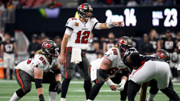 Dec 5, 2021; Atlanta, Georgia, USA; Tampa Bay Buccaneers quarterback Tom Brady (12) makes a pre-snap call as guard Alex Cappa (65) and center Ryan Jensen (66) are shown during the second half against the Atlanta Falcons at Mercedes-Benz Stadium. Mandatory Credit: Jason Getz-USA TODAY Sports