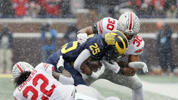 Ohio State Buckeyes linebacker Steele Chambers (22) and Ohio State Buckeyes linebacker Cody Simon (30) tackle Michigan Wolverines running back Hassan Haskins (25) during the first quarter of their NCAA College football at Michigan Stadium at Ann Arbor, Mi on November 27, 2021.Osu21um Kwr 19
