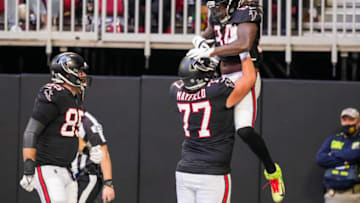 Dec 26, 2021; Atlanta, Georgia, USA; Atlanta Falcons running back Cordarrelle Patterson (84) reacts with guard Jalen Mayfield (77) after scoring a touchdown against the Detroit Lions during the first half at Mercedes-Benz Stadium. Mandatory Credit: Dale Zanine-USA TODAY Sports