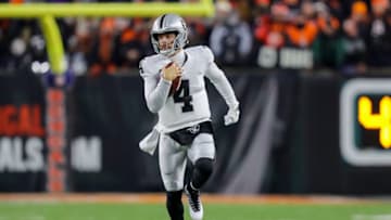 Jan 15, 2022; Cincinnati, Ohio, USA; Las Vegas Raiders quarterback Derek Carr (4) runs with the ball against the Cincinnati Bengals in the first half in an AFC Wild Card playoff football game at Paul Brown Stadium. Mandatory Credit: Katie Stratman-USA TODAY Sports