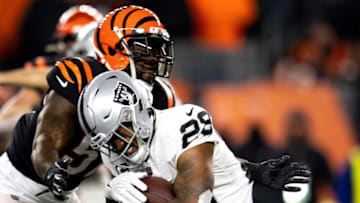 Cincinnati Bengals linebacker Germaine Pratt (57) tackles Las Vegas Raiders cornerback Casey Hayward Jr. (29) in the second half the AFC wild card game on Saturday, Jan. 15, 2022, at Paul Brown Stadium in Cincinnati. Cincinnati Bengals defeated Las Vegas Raiders 26-19.Las Vegas Raiders At Cincinnati Bengals Playoff Ac 188