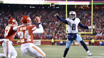 Tennessee Titans quarterback Marcus Mariota (8) throws a pass that was deflected by Kansas City Chiefs but was ultimately caught by Mariota for a touchdown during the AFC Wild Card game at Arrowhead Stadium in Kansas City, Mo., Jan. 6, 2018.