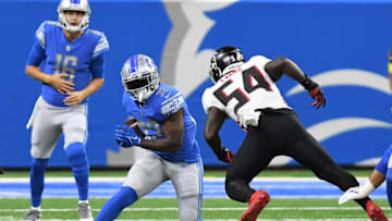Aug 12, 2022; Detroit, Michigan, USA; Detroit Lions running back D'Andre Swift (32) (left) tries to avoid Atlanta Falcons linebacker Rahsaan Evans (54) in the first quarter at Ford Field. Mandatory Credit: Lon Horwedel-USA TODAY Sports