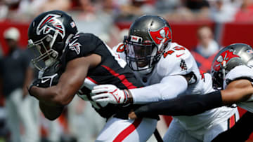 Oct 9, 2022; Tampa, Florida, USA; Atlanta Falcons running back Caleb Huntley (42) runs with the ball as Tampa Bay Buccaneers linebacker Devin White (45) tackles during the second quarter at Raymond James Stadium. Mandatory Credit: Kim Klement-USA TODAY Sports