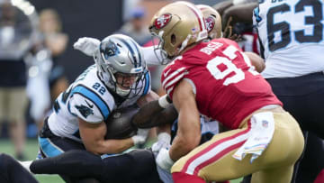 Oct 9, 2022; Charlotte, North Carolina, USA; Carolina Panthers running back Christian McCaffrey (22) runs into San Francisco 49ers defensive end Nick Bosa (97) during the second quarter at Bank of America Stadium. Mandatory Credit: Jim Dedmon-USA TODAY Sports
