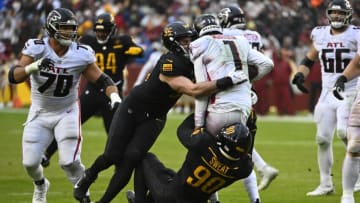 Nov 27, 2022; Landover, Maryland, USA; Washington Commanders defensive end Montez Sweat (90) and defensive end Casey Toohill (95) sacks Atlanta Falcons quarterback Marcus Mariota (1) during the second half at FedExField. Mandatory Credit: Brad Mills-USA TODAY Sports