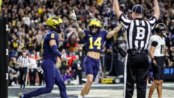 Michigan wide receiver Ronnie Bell (8) celebrates a touchdown with wide receiver Roman Wilson (14) during the second half of the Big Ten Championship game at Lucas Oil Stadium in Indianapolis, Ind., on Saturday, Dec. 3, 2022.