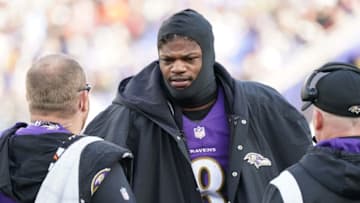 Dec 4, 2022; Baltimore, Maryland, USA; Baltimore Ravens quarterback Lamar Jackson (8) talks with team staff on the sideline in the second quarter after being sacked against the Denver Broncos at M&T Bank Stadium. Mandatory Credit: Mitch Stringer-USA TODAY Sports