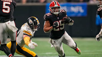 Dec 4, 2022; Atlanta, Georgia, USA; Atlanta Falcons running back Tyler Allgeier (25) runs past Pittsburgh Steelers linebacker T.J. Watt (90) during the second half at Mercedes-Benz Stadium. Mandatory Credit: Dale Zanine-USA TODAY Sports