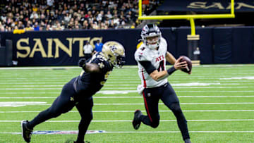 Dec 18, 2022; New Orleans, Louisiana, USA; New Orleans Saints defensive end Payton Turner (98) chases Atlanta Falcons quarterback Desmond Ridder (4) out the poclketduring the second half at Caesars Superdome. Mandatory Credit: Stephen Lew-USA TODAY Sports
