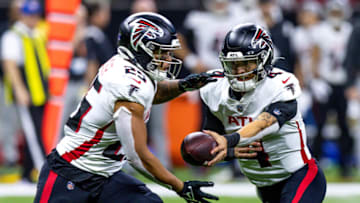 Dec 18, 2022; New Orleans, Louisiana, USA; New Orleans Saints punter Blake Gillikin (4) hands the ball off to running back Tyler Allgeier (25) against the New Orleans Saints during the second half at Caesars Superdome. Mandatory Credit: Stephen Lew-USA TODAY Sports
