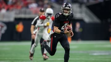Jan 1, 2023; Atlanta, Georgia, USA; Atlanta Falcons quarterback Desmond Ridder (4) scrambles against the Arizona Cardinals in the first half at Mercedes-Benz Stadium. Mandatory Credit: Brett Davis-USA TODAY Sports