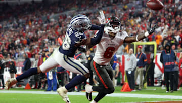 Jan 16, 2023; Tampa, Florida, USA; Tampa Bay Buccaneers wide receiver Julio Jones (6) attempts to make a catch against Dallas Cowboys cornerback DaRon Bland (26) in the second half during the wild card game at Raymond James Stadium. Mandatory Credit: Nathan Ray Seebeck-USA TODAY Sports