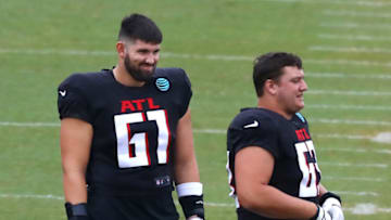 Aug 24, 2020; Flowery Branch, GA, USA; Atlanta Falcons rookie center Matt Hennessy (left) and guard Chris Lindstrom take the field for the second scrimmage on Monday, August 24, 2020 in Flowery Branch. Mandatory Credit: Curtis Compton/Pool Photo via USA TODAY Sports