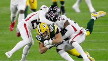 Green Bay Packers tight end Robert Tonyan (85) dives for a first down reception against Atlanta Falcons strong safety Damontae Kazee (27) and Jaylinn Hawkins (32) in the first quarter during their football game Monday, Oct. 5, 2020, at Lambeau Field in Green Bay, Wis.Apc Packvsfalcons 1005200265