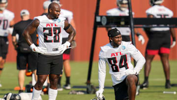 Jul 29, 2021; Flowery Branch, GA, USA; Atlanta Falcons running back Mike Davis (28) and wide receiver Cordarrelle Patterson (84) on the field during the first day of training camp practice at the Atlanta Falcons Training Facility. Mandatory Credit: Dale Zanine-USA TODAY Sports