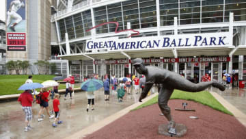 CINCINNATI, OH - JULY 4: Fans walk in the rain past the statue of former Cincinnati Reds pitcher Joe Nuxhall on their way to the game against the San Francisco Giants at Great American Ball Park on July 4, 2013 in Cincinnati, Ohio. (Photo by Joe Robbins/Getty Images)