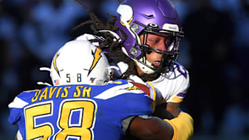 CARSON, CA - DECEMBER 15: Running back Mike Boone #23 of the Minnesota Vikings drags outside linebacker Thomas Davis #58 of the Los Angeles Chargers into the end zone as he goes for a touchdown in the second half of the game at Dignity Health Sports Park on December 15, 2019 in Carson, California. (Photo by Jayne Kamin-Oncea/Getty Images)