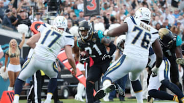 JACKSONVILLE, FL - NOVEMBER 12: A.J. Bouye #21 of the Jacksonville Jaguars runs with the football after an interception in overtime of their game against the Los Angeles Chargers at EverBank Field on November 12, 2017 in Jacksonville, Florida. (Photo by Logan Bowles/Getty Images)