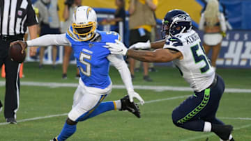 CARSON, CA - AUGUST 24: Tyrod Taylor #5 of the Los Angeles Chargers runs out of the pocket to get away from Mychal Kendricks #56 of the Seattle Seahawks in the first quarter during a pre-season NFL football game at Dignity Health Sports Park on August 24, 2019 in Carson, California. (Photo by John McCoy/Getty Images)