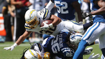 CARSON, CALIFORNIA - SEPTEMBER 08: Austin Ekeler #30 of the Los Angeles Chargers runs over Clayton Geathers #26 of the Indianapolis Colts on a short run during the first half of a game at Dignity Health Sports Park on September 08, 2019 in Carson, California. (Photo by Sean M. Haffey/Getty Images)