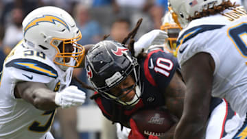 CARSON, CALIFORNIA - SEPTEMBER 22: Wide receiver DeAndre Hopkins #10 of the Houston Texans runs the ball through outside linebacker Thomas Davis #58 and defensive tackle Justin Jones #93 of the Los Angeles Chargers at Dignity Health Sports Park on September 22, 2019 in Carson, California. (Photo by Meg Oliphant/Getty Images)