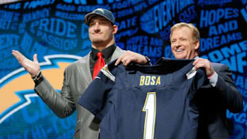 CHICAGO, IL - APRIL 28: (L-R) Joey Bosa of Ohio State holds up a jersey with NFL Commissioner Roger Goodell after being picked