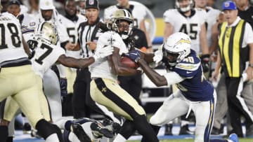 CARSON, CA - AUGUST 20: Running back Darius Victor #34 of the New Orleans Saints hangs on to the ball as defensive end Chris McCain #40 of the Los Angeles Chargers tries to strip it from him during the second half of a preseason football game against the New Orleans Saints at the StubHub Center August 20, 2017, in Carson, California. (Photo by Kevork Djansezian/Getty Images)