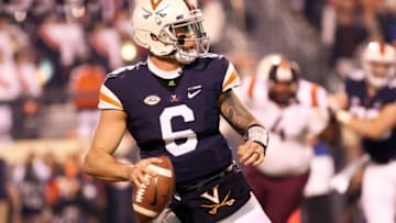 CHARLOTTESVILLE, VA - NOVEMBER 24: Kurt Benkert #6 of the Virginia Cavaliers scrambles in the second quarter during a game against the Virginia Tech Hokies at Scott Stadium on November 24, 2017 in Charlottesville, Virginia. (Photo by Ryan M. Kelly/Getty Images)
