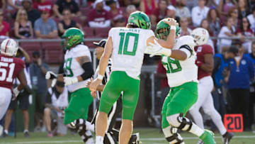 PALO ALTO, CA - SEPTEMBER 21: Justin Herbert #10 and Penei Sewell #58 of the Oregon Ducks celebrate a touchdown pass during an NCAA Pac-12 college football game against the Stanford Cardinal on September 21, 2019 at Stanford Stadium in Palo Alto, California. (Photo by David Madison/Getty Images)