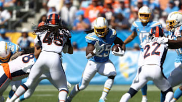 CARSON, CALIFORNIA - OCTOBER 06: Melvin Gordon #25 of the Los Angeles Chargers runs the ball as Kareem Jackson #22 and Alexander Johnson #45 of the Denver Broncos defend during the first half of a game at Dignity Health Sports Park on October 06, 2019 in Carson, California. (Photo by Sean M. Haffey/Getty Images)