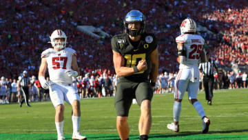 PASADENA, CALIFORNIA - JANUARY 01: Justin Herbert #10 of the Oregon Ducks celebrates after scoring a four yard touchdown against the Wisconsin Badgers during the first quarter in the Rose Bowl game presented by Northwestern Mutual at Rose Bowl on January 01, 2020 in Pasadena, California. (Photo by Sean M. Haffey/Getty Images)