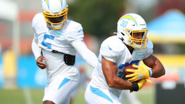 COSTA MESA, CALIFORNIA - AUGUST 20: Tyrod Taylor #5 of the Los Angeles Chargers hands the ball of to Austin Ekeler #30 during the Los Angeles Chargers Training Camp at the Jack Hammett Sports Complex on August 20, 2020 in Costa Mesa, California. (Photo by Joe Scarnici/Getty Images)