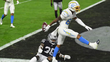LAS VEGAS, NEVADA - DECEMBER 17: Wide receiver Tyron Johnson #83 of the Los Angeles Chargers celebrates scoring a touchdown as Daryl Worley #36 of the Las Vegas Raiders looks on during the first half at Allegiant Stadium on December 17, 2020 in Las Vegas, Nevada. (Photo by Ethan Miller/Getty Images)