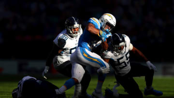 LONDON, ENGLAND - OCTOBER 21: Austin Ekeler of Los Angeles Chargers is brought down by Jayon Brown of Tennessee Titans during the NFL International Series match between Tennessee Titans and Los Angeles Chargers at Wembley Stadium on October 21, 2018 in London, England. (Photo by Naomi Baker/Getty Images)