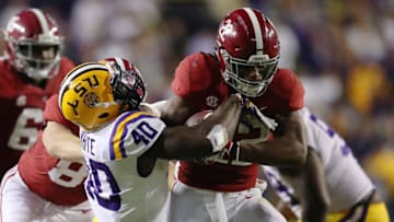 BATON ROUGE, LA - NOVEMBER 03: Najee Harris #22 of the Alabama Crimson Tide battles for yards while being tackled by Devin White #40 of the LSU Tigers during a second half run at Tiger Stadium on November 3, 2018 in Baton Rouge, Louisiana. Alabama won the game 29-0. (Photo by Gregory Shamus/Getty Images)